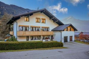 a large white house with a black roof at Haus Gant in Sankt Gallenkirch