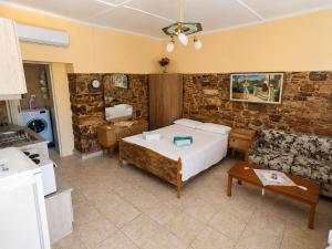 a bedroom with a bed and a living room at Elegant Studio in Chios near the Beach and Port in Chios