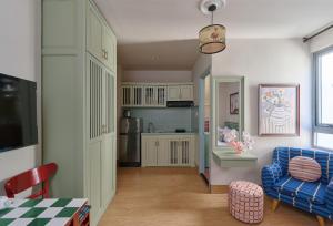 a living room with a blue couch and a kitchen at LangX Heaven Hotel & Apartment in Danang +61 photos