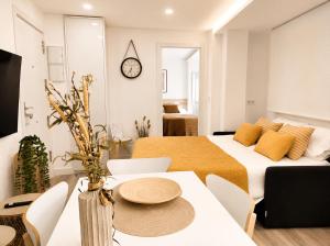 a living room with a bed and a table and chairs at Sisargas Playa in Malpica +30 photos