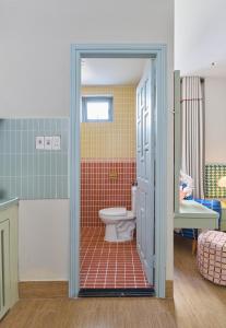 a bathroom with a toilet and a sink at LangX Heaven Hotel & Apartment in Danang