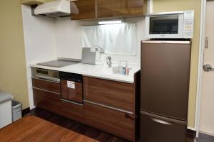 a kitchen with a sink and a microwave at Wallaby House in Kawaguchi +31 photos