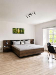 a bedroom with a bed and a table and chairs at Gut Rottmannshagen Mecklenburgische Seenplatte in Jürgenstorf