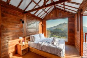 a bedroom with a bed with a cat laying on it at Kamani Cabin by Moria in Kubupenlokan