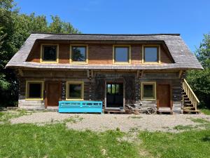 a log home with a blue front porch at Breb 220D in Breb