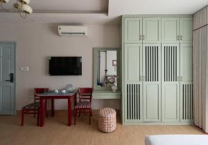 a living room with a table and chairs and a tv at LangX Heaven Hotel & Apartment in Danang