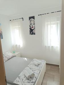 a bedroom with a bed with towels on it at Apartment Domagoj, Novalja,with 3 air conditioning units in Novalja