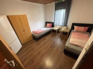 a small room with a bed and a couch at Aparthotel Boardinghouse BRACK mit Parkplatz Küche WIFI in Bielefeld +3 photos