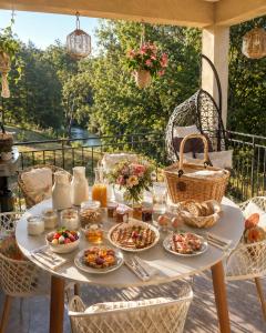 a table with breakfast food on a patio at Chambres d'hôte Casprese in Altiani