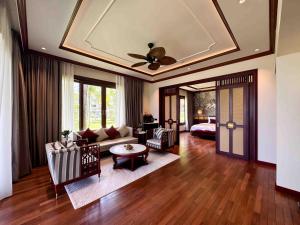 a living room with a couch and a ceiling at Sunny Beach Resort & Spa Mui Ne in Mui Ne