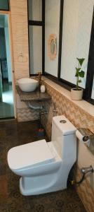 a bathroom with a white toilet and a sink at NAMAKA, Morjim and Ashwem Beach 300m away in Morjim +66 photos