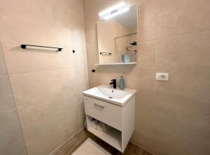 a bathroom with a white sink and a mirror at Apartments Vicelić in Lovište +36 photos