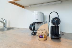 a kitchen counter with a coffee maker and a basket of apples at Haus Gant in Sankt Gallenkirch