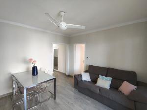 a living room with a couch and a table at Apartaments Lamoga - Sandi in Torredembarra