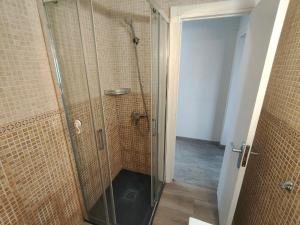 a shower with a glass door in a bathroom at Apartaments Lamoga - Sandi in Torredembarra +16 photos