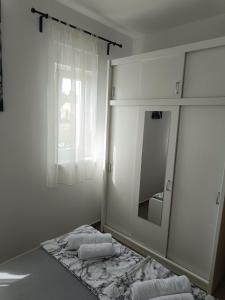 a bathroom with a mirror and towels on the floor at Apartment Domagoj, Novalja,with 3 air conditioning units in Novalja +20 photos