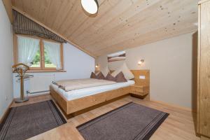 a bedroom with a bed and a wooden ceiling at Haus Gant in Sankt Gallenkirch