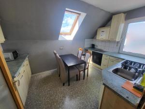 a small kitchen with a table and a sink at Aparthotel Boardinghouse BRACK mit Parkplatz Küche WIFI in Bielefeld