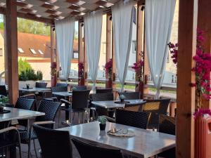 a row of tables and chairs in a restaurant at Olymp Hotel in Magdeburg