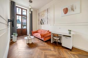 a living room with a couch and a table at Lumiere 28 Aparthotel in Łódź