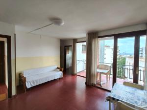 a living room with a couch and a balcony at Lamoga Ona in Torredembarra