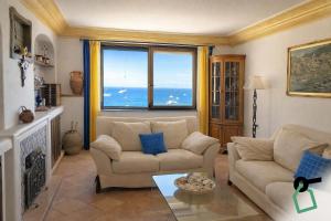 a living room with a couch and a large window at Hotiday Positano Suites and View in Positano