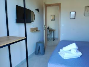 a room with a bed with towels on it at Johnhara Studios & Apartments in Ialysos