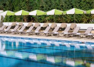 a row of chairs sitting next to a swimming pool at Brown Jerusalem Hotel in Jerusalem