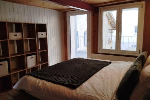 a bedroom with a bed and a large window at 20 Min nach Interlaken in Frutigen +12 photos