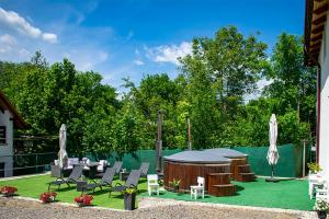 a backyard with a gazebo and chairs and a table at Pensiunea Mariana in Ocna Şugatag