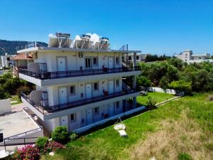 an apartment building with satellites on top of it at Johnhara Studios & Apartments in Ialysos