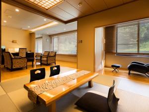a living room with a couch and a table at Seiryukaku in Hachimantai +58 photos