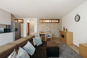 a living room with a couch and a dining room at Villa Maria Caetana in Frazão