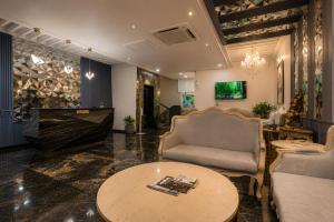 a living room with a couch and a table at The Belmonte House by Noventa - Rooftop Pool Hotel in Udaipur in Udaipur