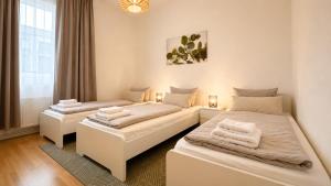 a bedroom with two beds with towels on them at URBAN FLATS Berlin in Berlin +270 photos