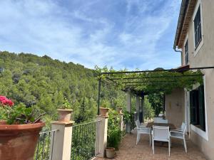a patio with a table and chairs on a balcony at Tramuntana Sunset in Port de Soller