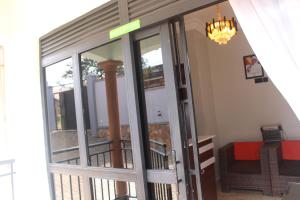 an entrance to a building with a glass door at Crown Suites Motel in Masaka