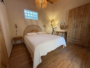 a bedroom with a large white bed and a window at Bohemian Residence in Paradeísion