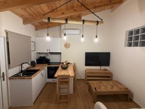 a small kitchen with a table and a tv at Bohemian Residence in Paradeísion
