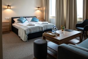a hotel room with a bed and a coffee table at Mangal Hotel in Olgina +40 photos