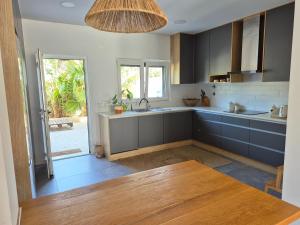 a kitchen with a sink and a counter top at Ribavilla Surf House in Santo Isidoro