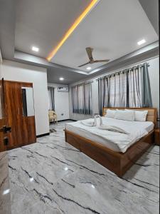 a bedroom with a large bed with a marble floor at Hotel Pooja Inn Pandharpur in Pandharpur