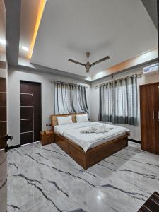 a bedroom with a bed and a large rug at Hotel Pooja Inn Pandharpur in Pandharpur