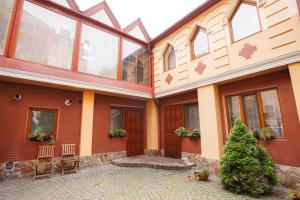 a large building with glass doors and a courtyard at Avenue Hotel in Chernivtsi