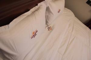 a white shirt with red crosses on it at Crown Suites Motel in Masaka +9 photos