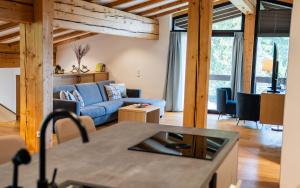 a kitchen and living room with a blue couch at Panorama Quartier Seefeld in Seefeld in Tirol