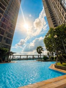 a large swimming pool between two tall buildings at Eco Green Apartment Residence District 7 in Ho Chi Minh City