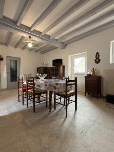 a dining room with a table and chairs at La ferme des Gabelles in Saint-Benoît-sur-Loire