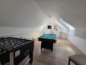 a room with a ping pong table in a room at Ferienhaus Eifel Horizont in Neuheilenbach