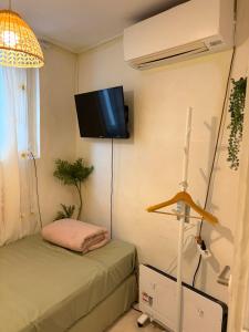 a room with two beds and a tv on the wall at Stay Everyday in Seoul